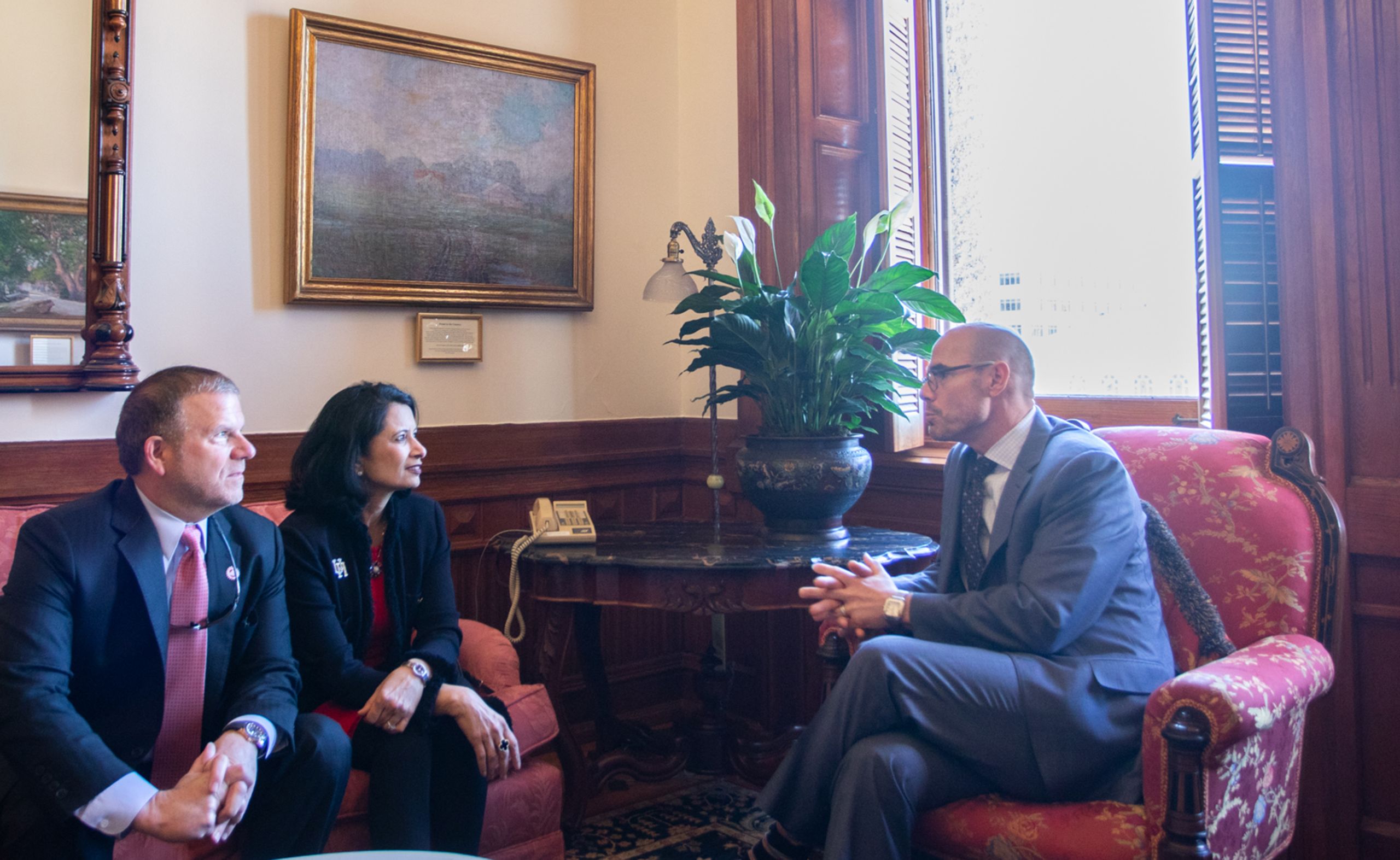 UH System Chairman Tilman Fertitta and UH President Renu Khator sit on couch across from House Speaker Dennis Bonnen.